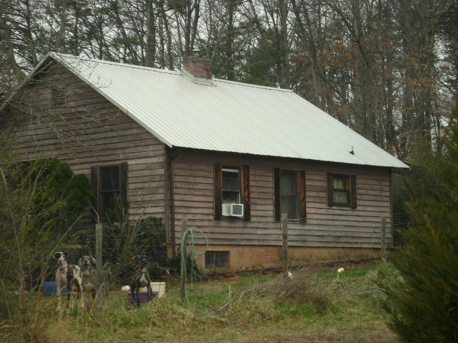White metal roof on an old wood sided farmhouse, from a Metal Roof Installation job in La Vernia